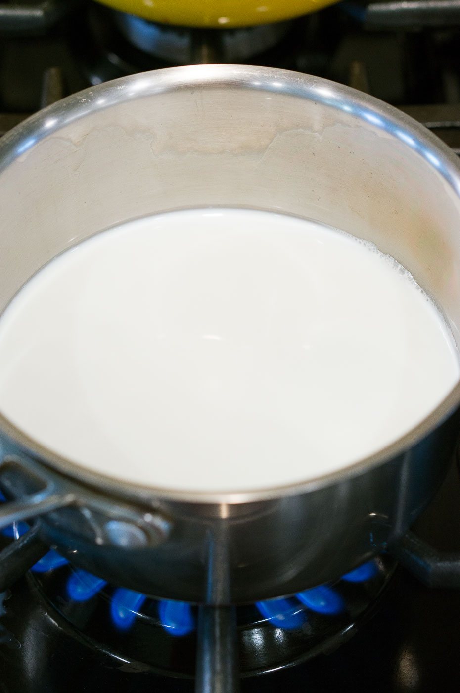 simmering milk in a pan on cooktop