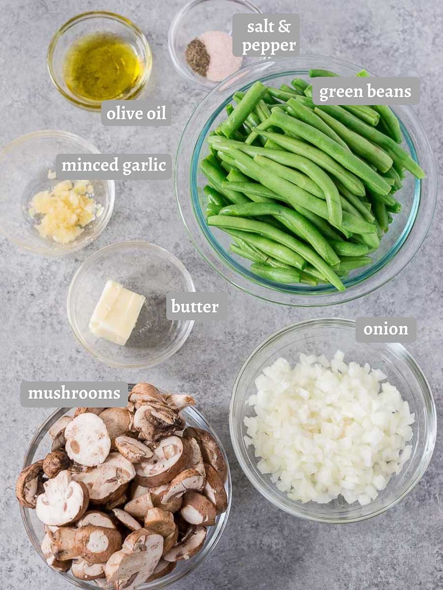 green beans, onions, mushrooms, and condiments on a board
