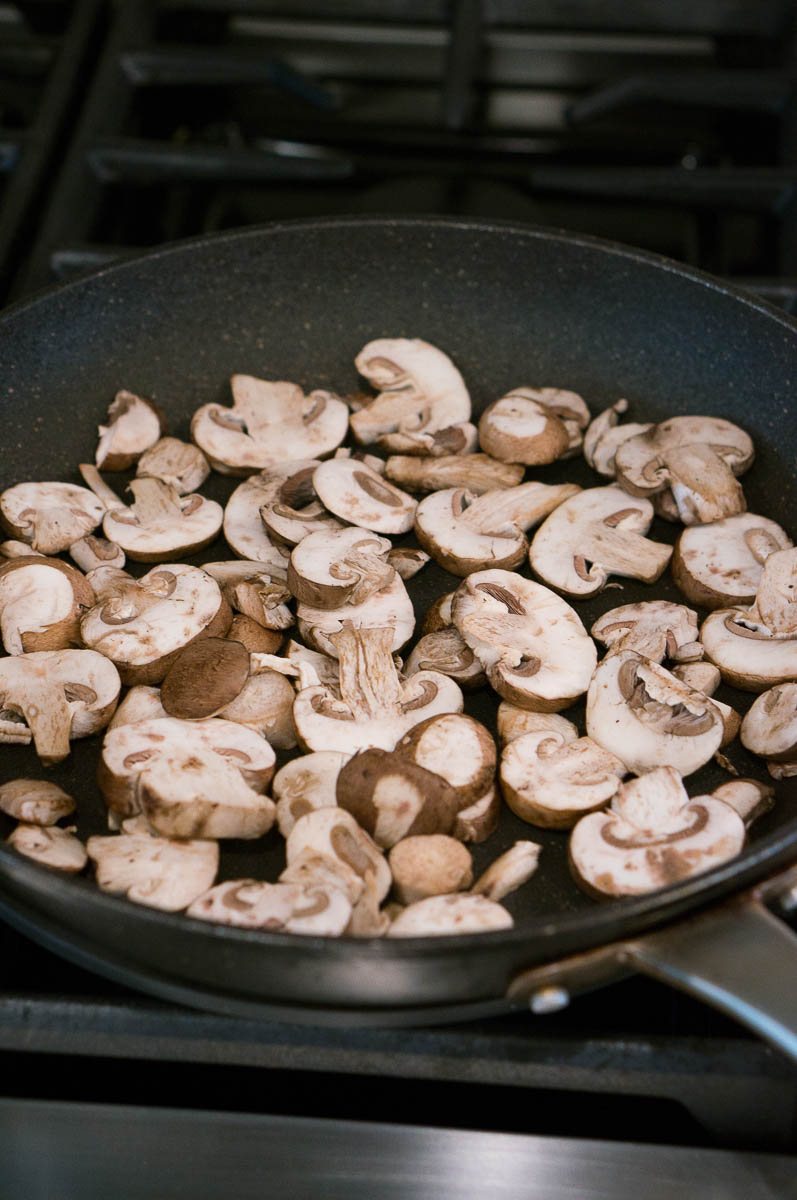 Mushrooms sauteeing in a pan