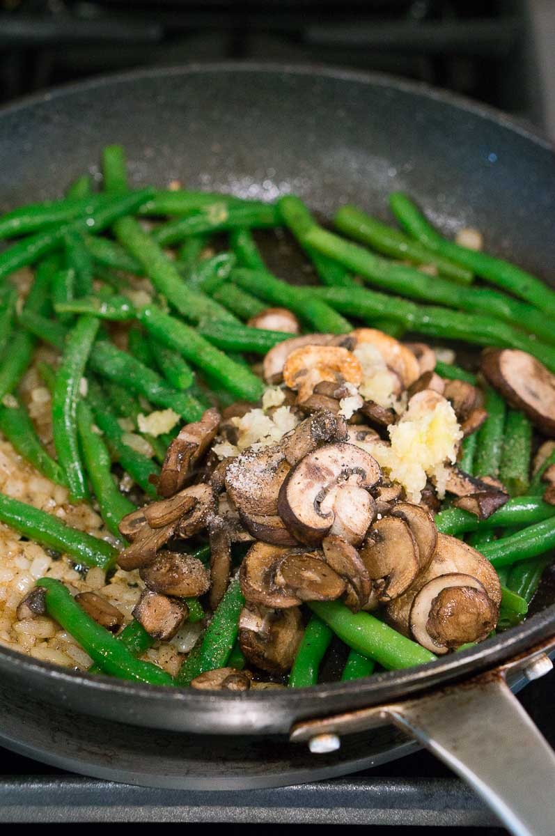 Cooked Green Beans, Mushrooms and onions in a skillet