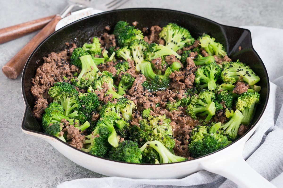 ground beef and broccoli stir fry in a skillet