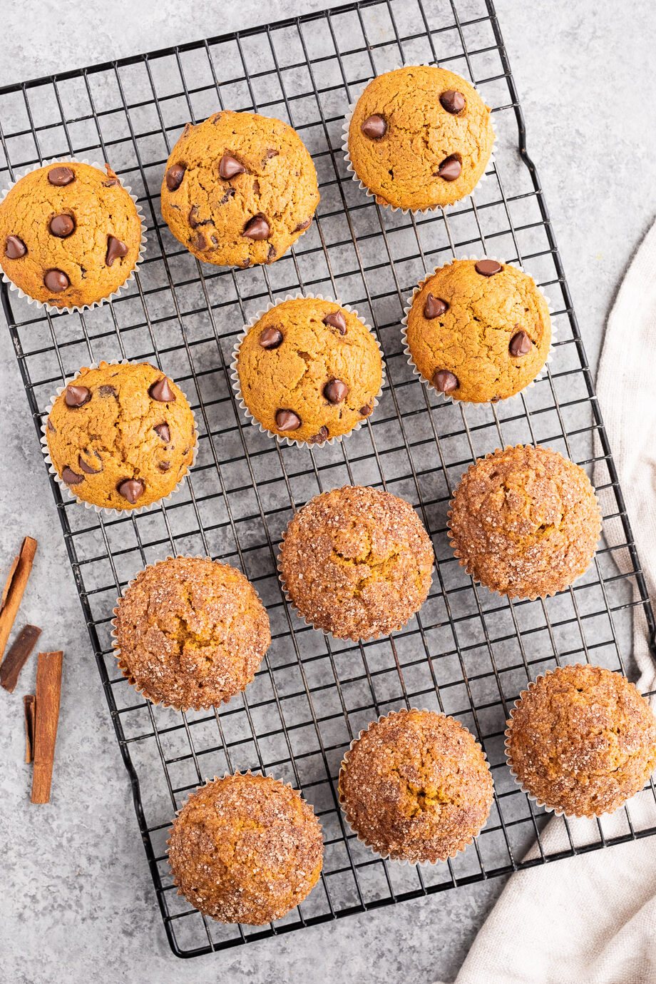 pumpkin chocolate chip muffins and cinnamon sugar pumpkin muffins on a wire rack