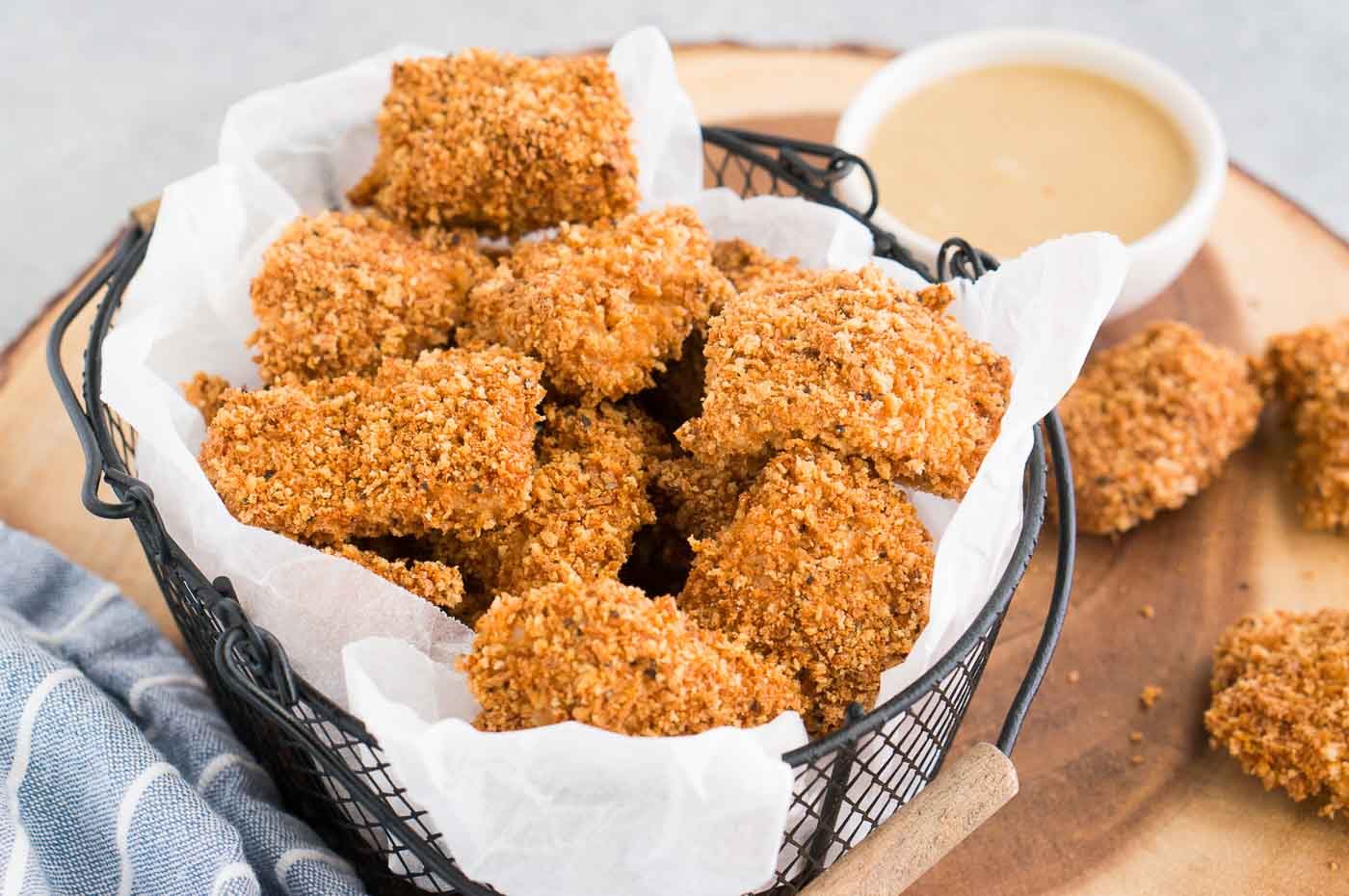 chicken nuggets in a basket and honey mustard sauce