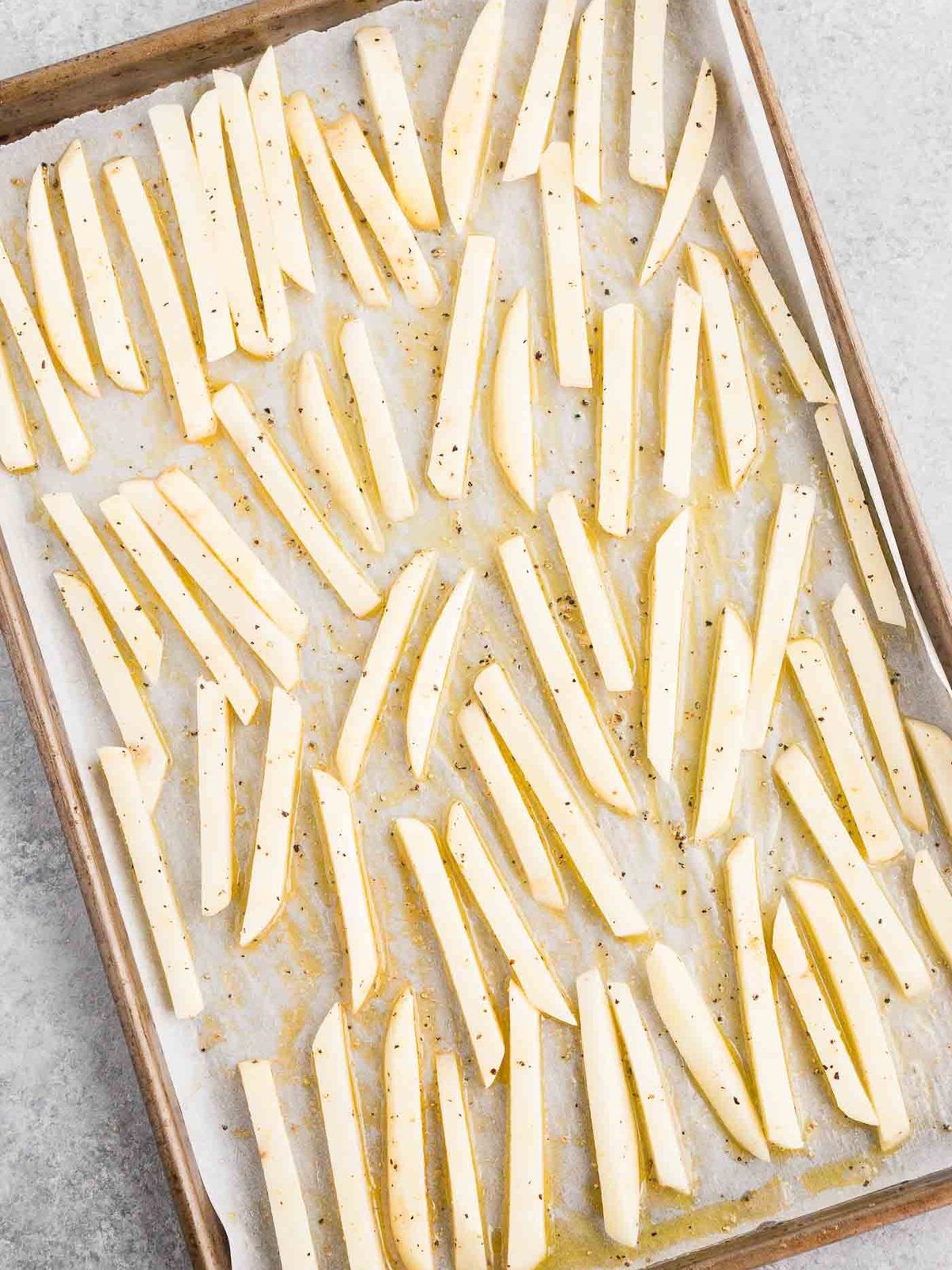 spread potato fries on a baking sheet before baking