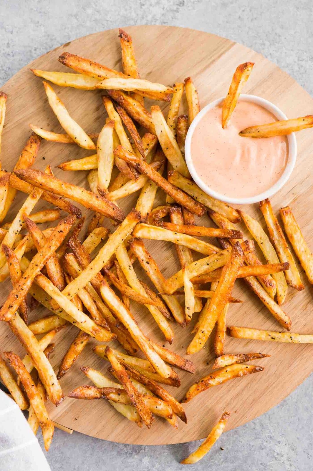 best homemade french fries served on a board with dipping sauce