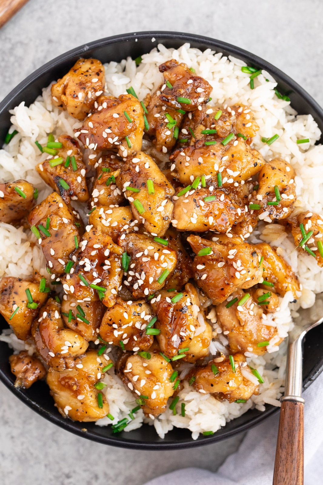 close up image of honey garlic chicken with sauce over rice