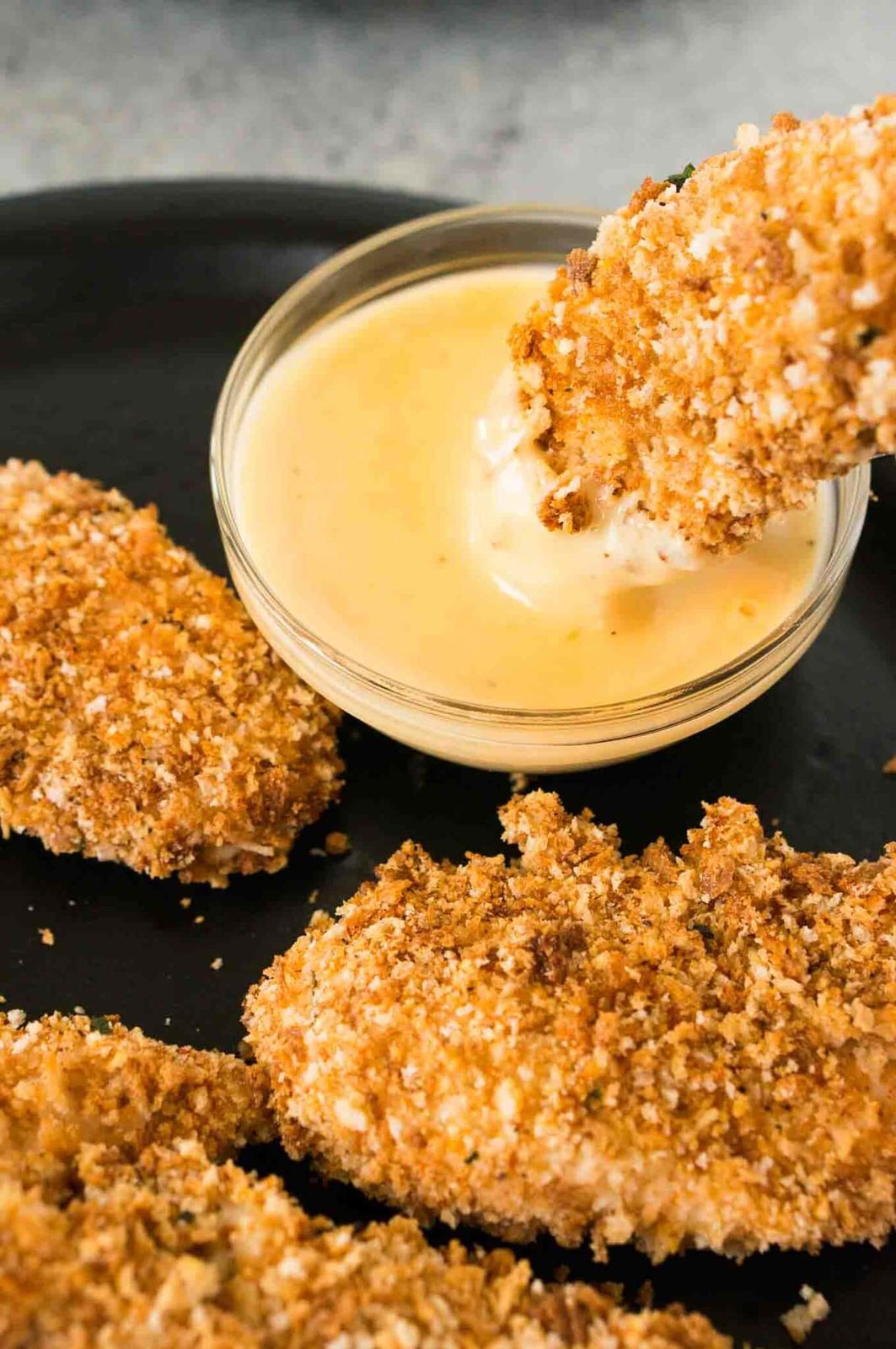 dipping chicken tenders in honey Dijon sauce