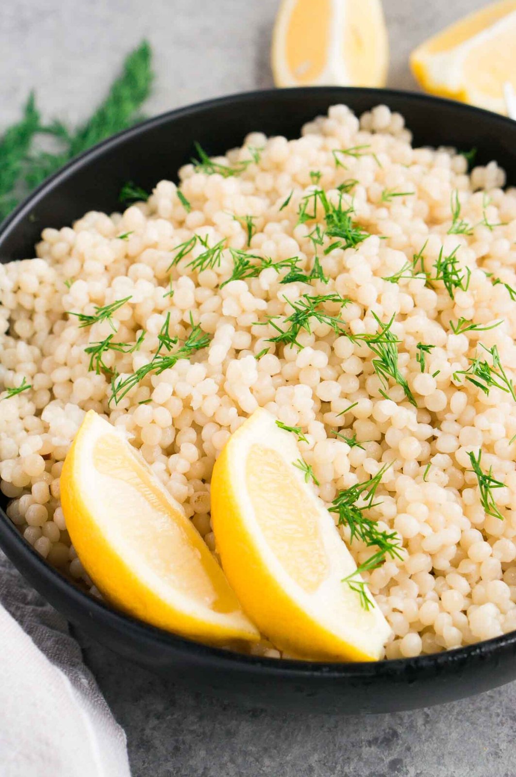 close up image of perfect couscous in a black bowl