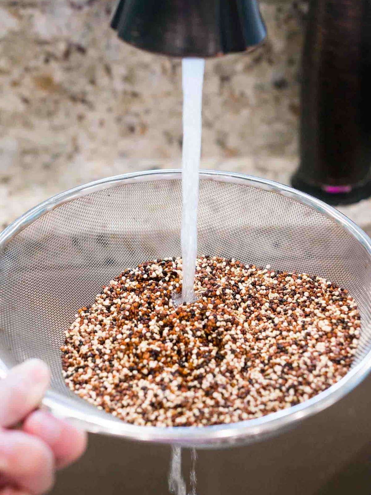 rinsing quinoa in a sieve