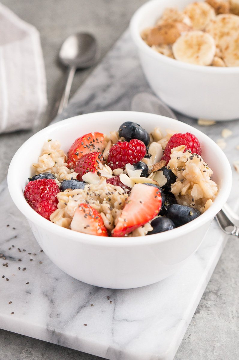 oatmeal served with berries almonds and maple syrup