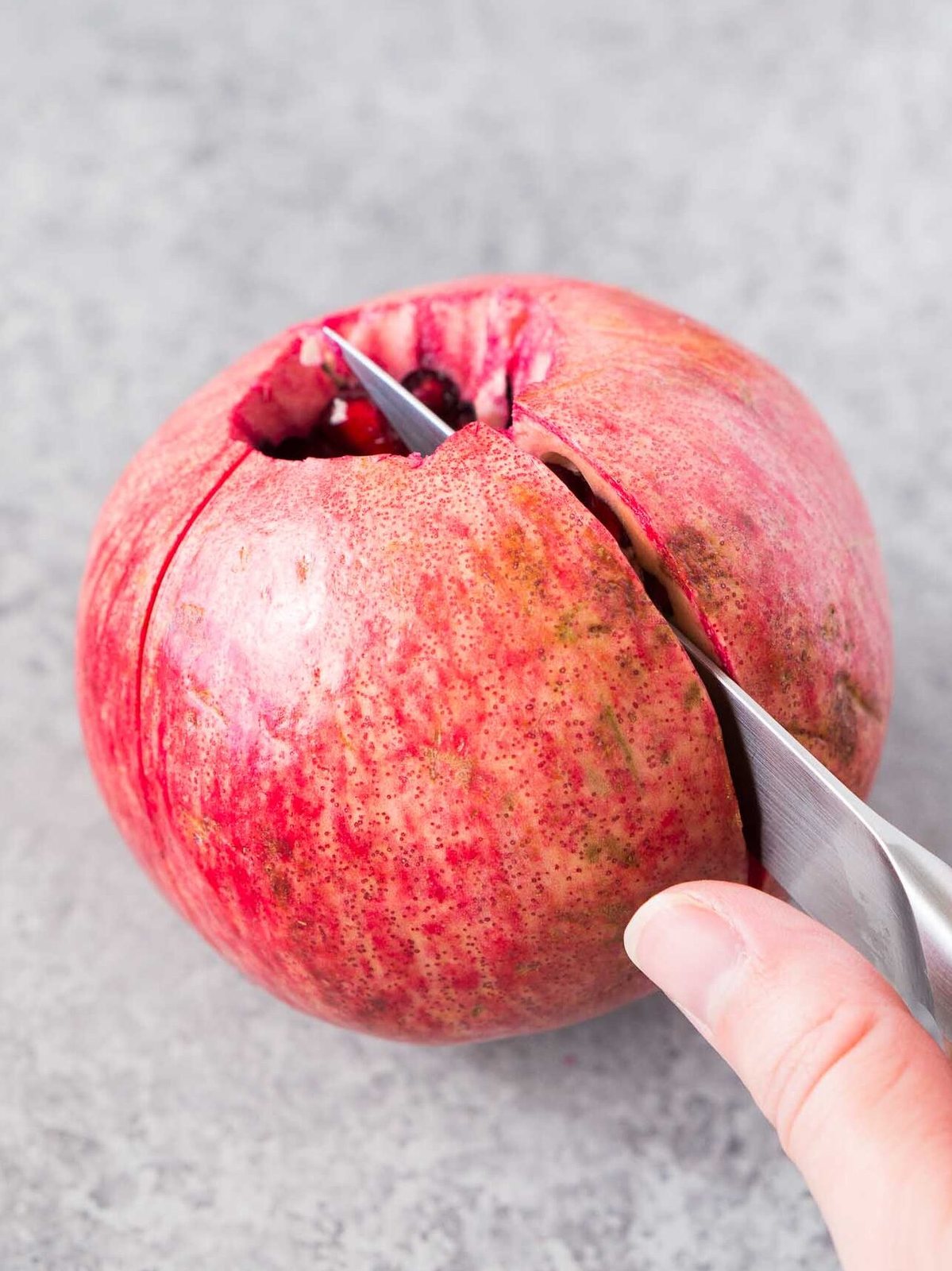 cutting a pomegranate along the ridges