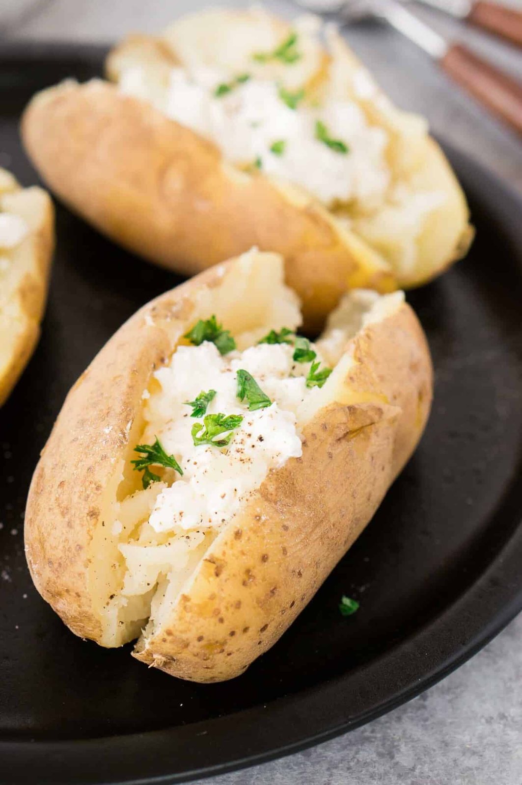 baked potatoes with sour cream on a plate