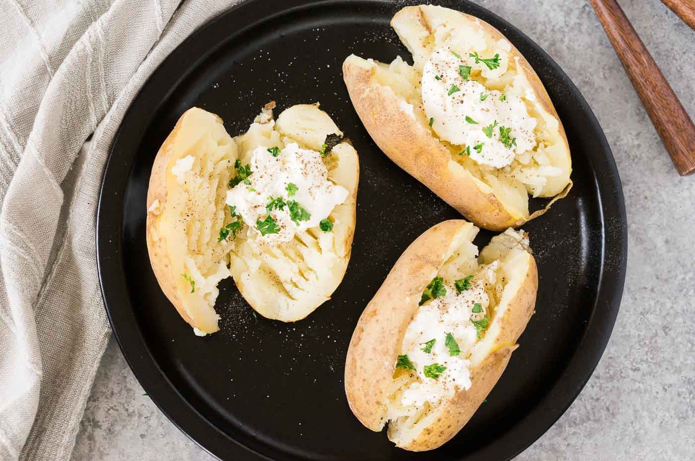 baked potatoes made in the instant pot topped with sour cream and chives