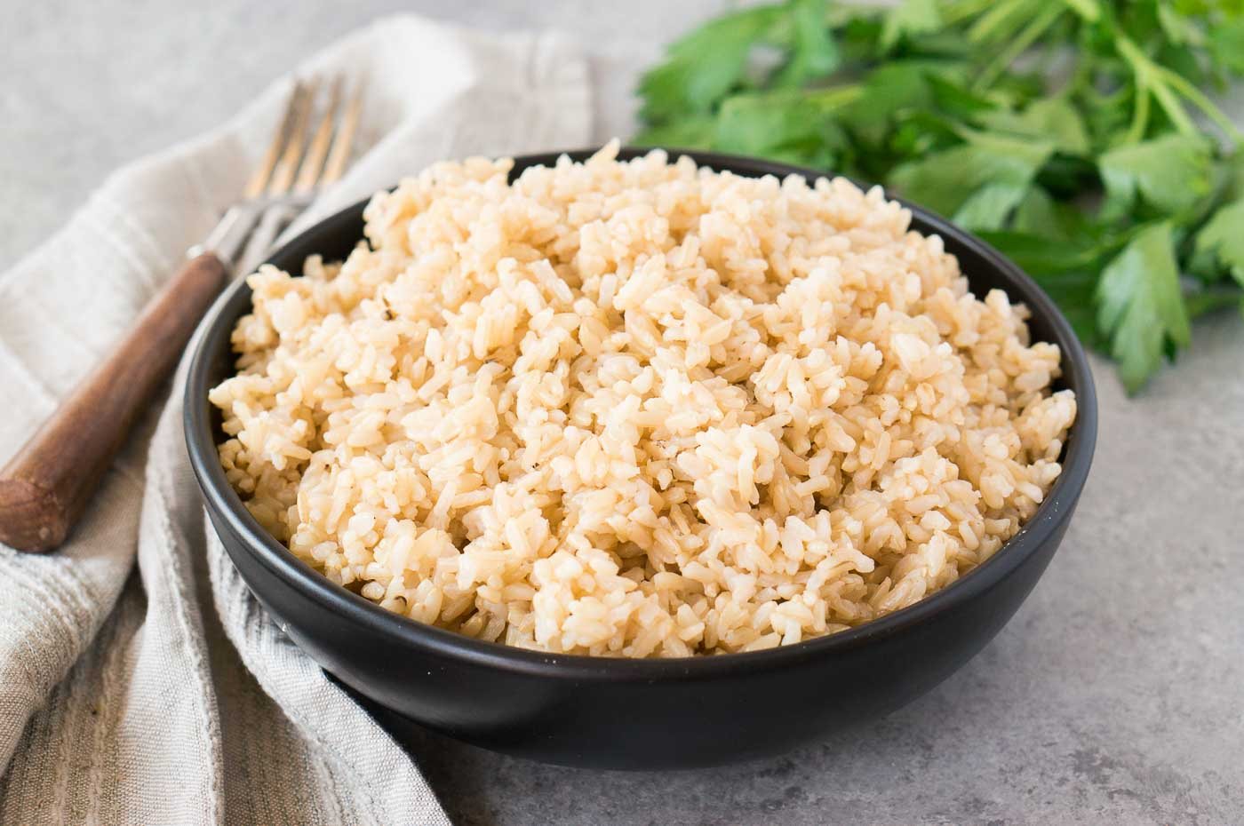instant pot brown rice in a black bowl