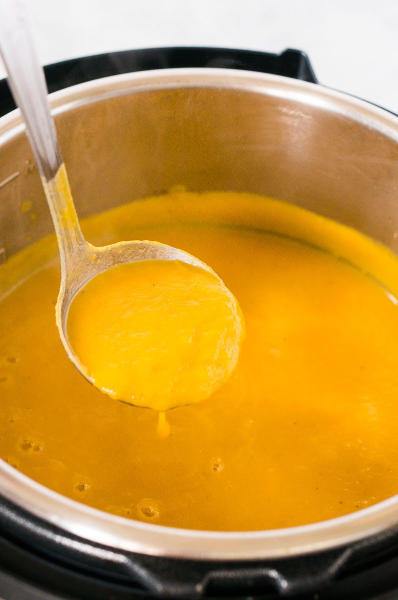 scoping a ladle of butternut squash soup