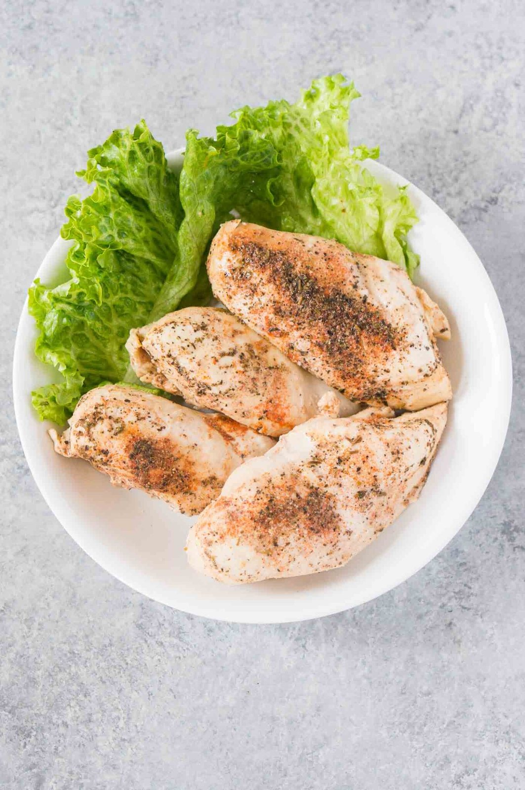 seasoned cooked chicken breasts on a plate