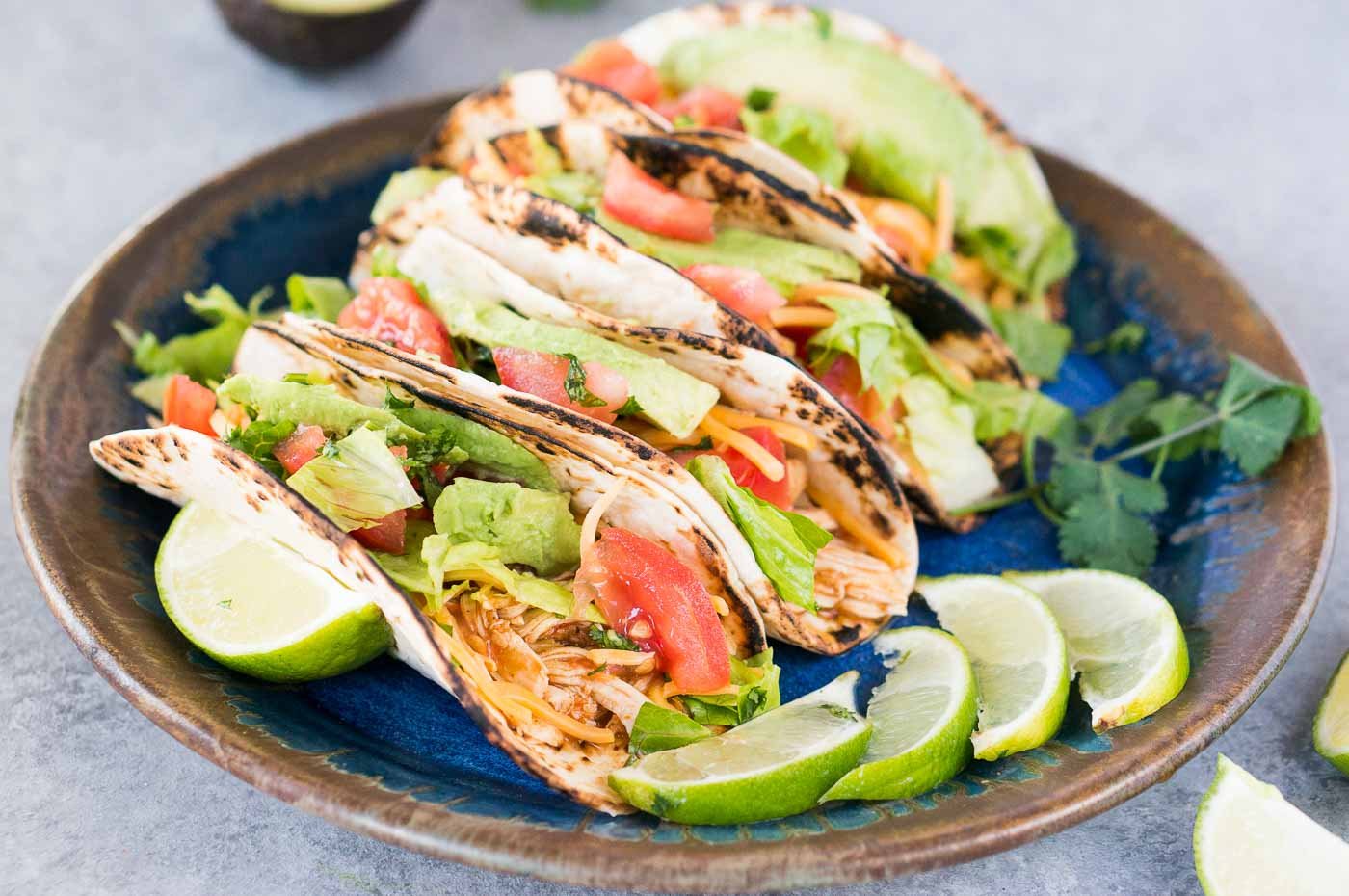 chicken tacos with toppings on a plate