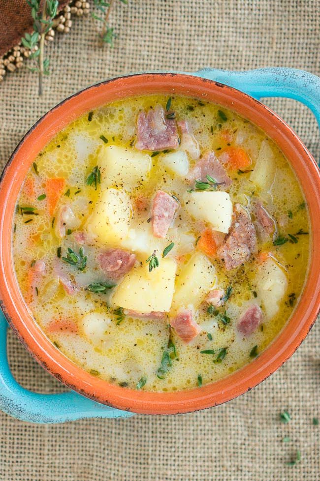image from top of the ham and potato soup in a clay bowl