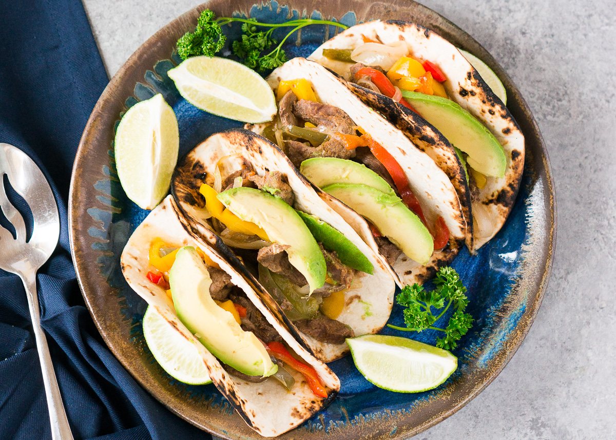 close up image of steak fajitas on a platter