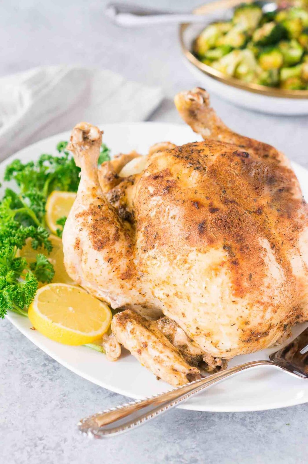pressure cooker whole chicken with lemon slices on a platter