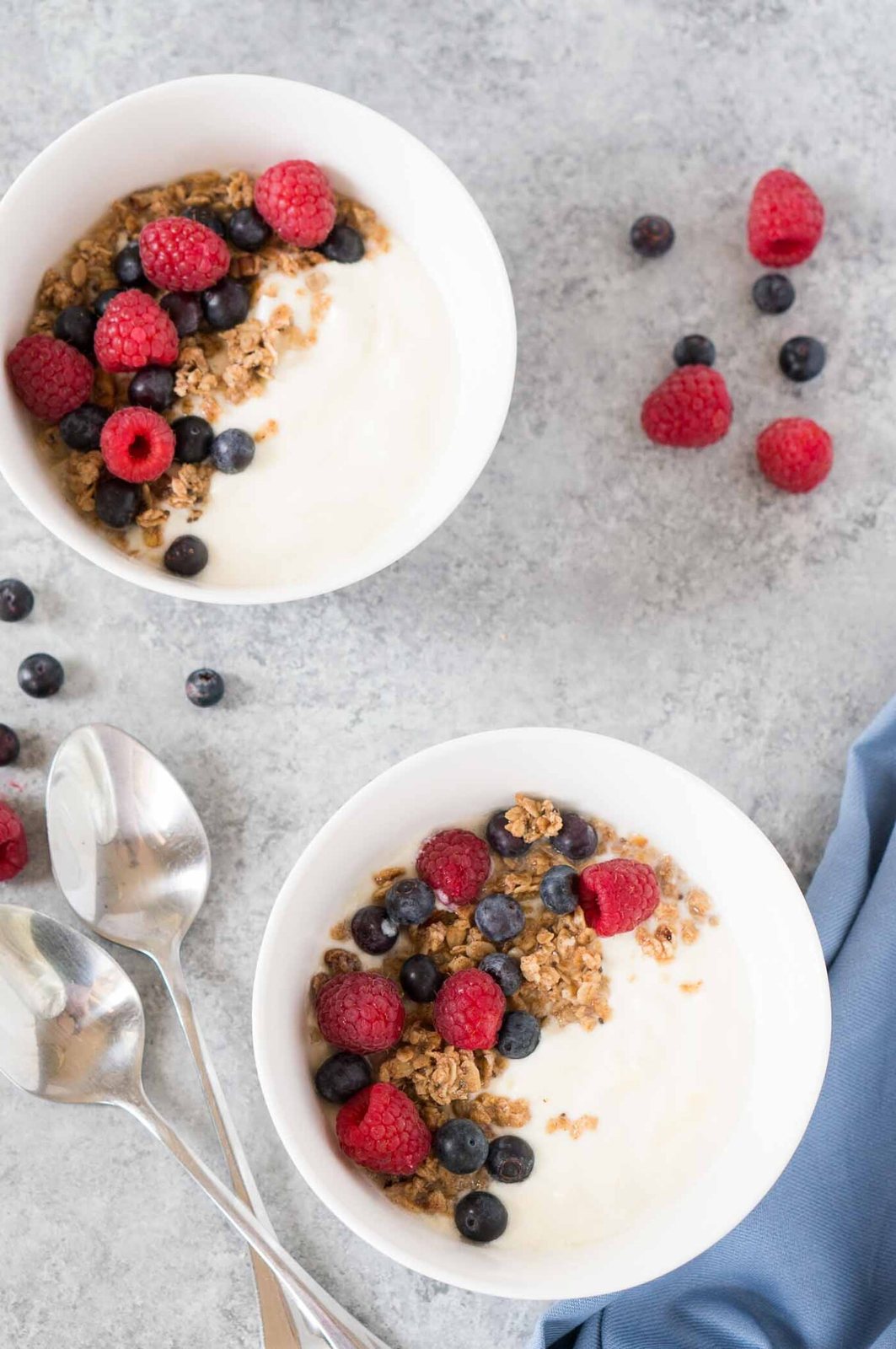 bowls of instant pot yogurt topped with granola and berries