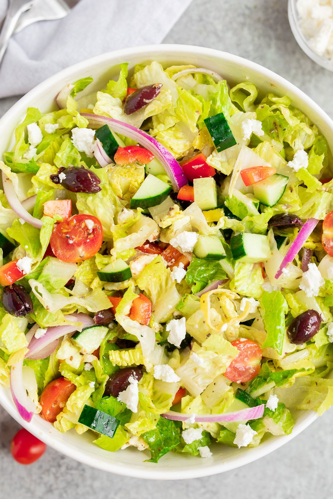 Easy Italian-style chopped salad tossed with homemade dressing, romaine lettuce, fresh vegetables, olives, and feta cheese