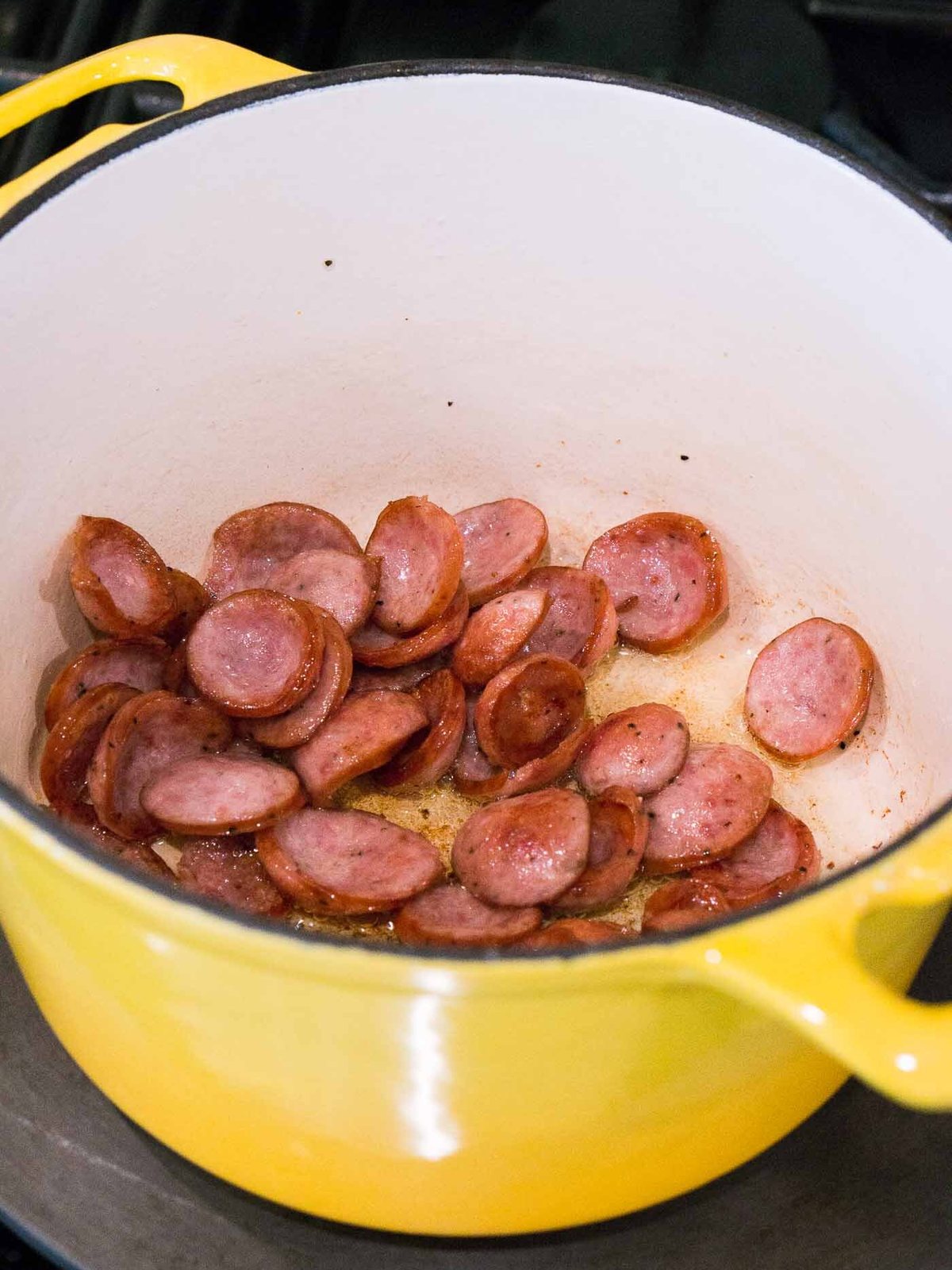 browing sausage in a pot