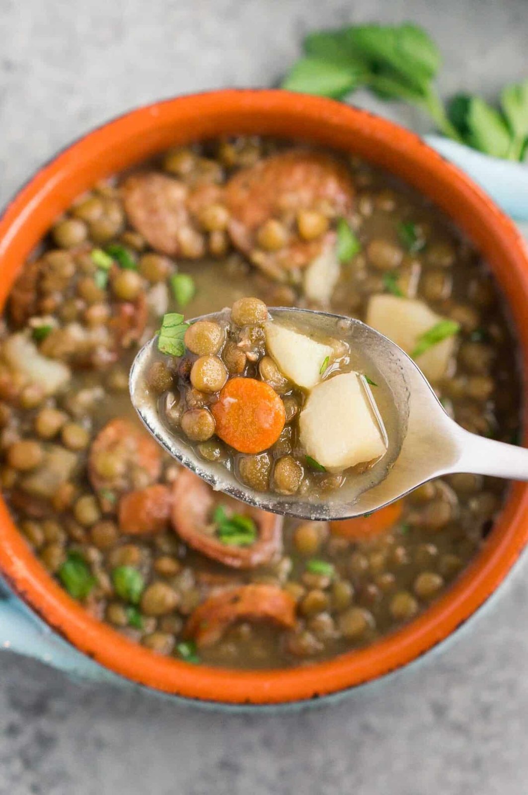 scooping vegetable soup from a bowl