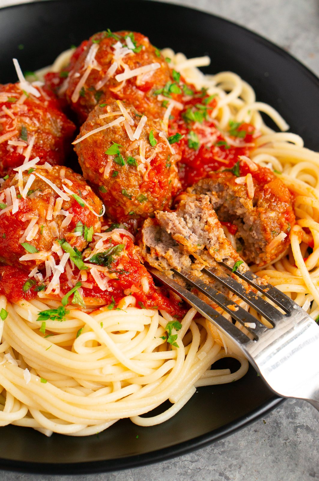 meatball cut in half with a fork