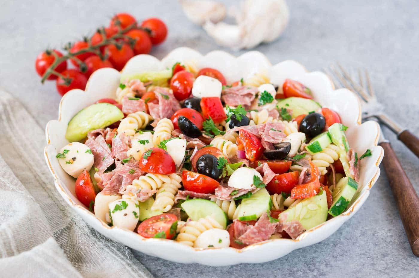 homemade pasta salad with tomatoes cucumbers salami and mozzarella