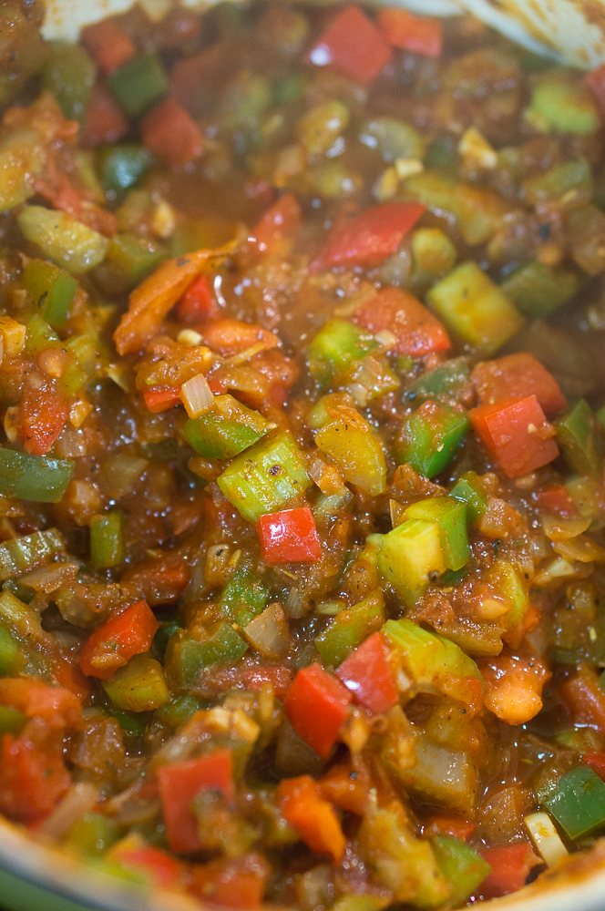 The vegetables mixed with the spices and tomato paste