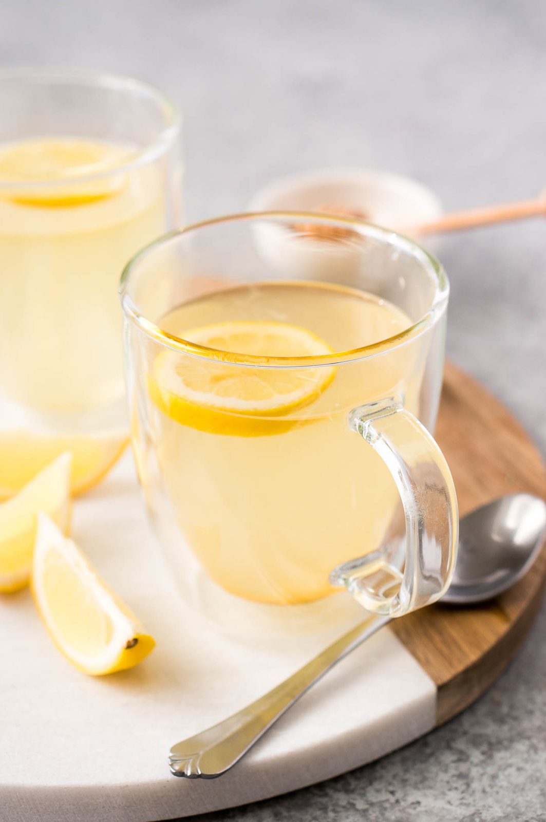 lemon tea with honey in a glass cup