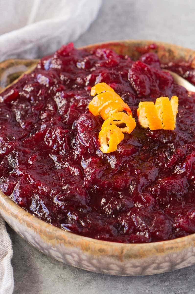 close up shot of orange cranberry sauce with orange peel swirls