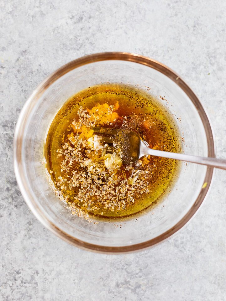Olive oil vinaigrette with garlic, oregano, red wine vinegar, and lemon juice for Greek maroulosalata