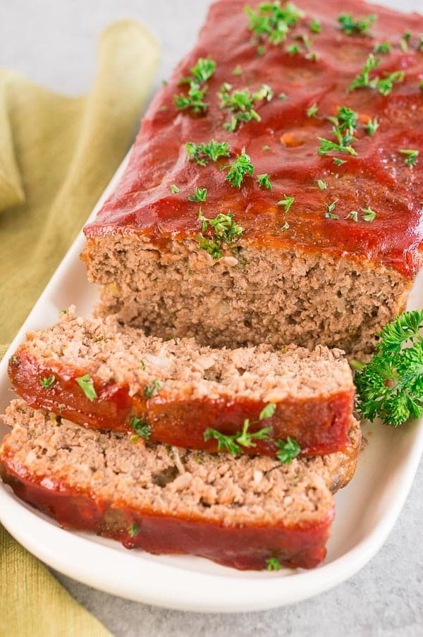 Classic homemade meatloaf with caramelized glaze sliced on a platter