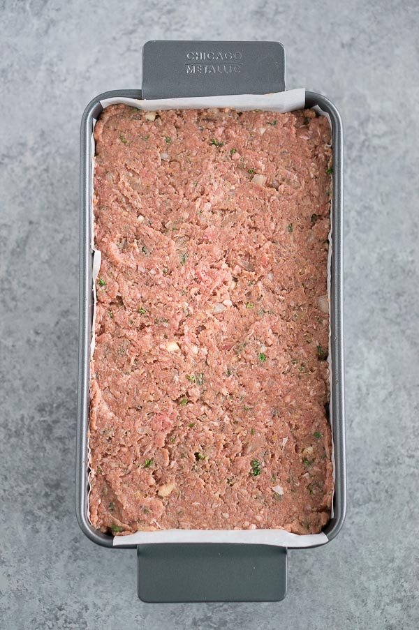 Uncooked homemade meatloaf ready to bake in a pan