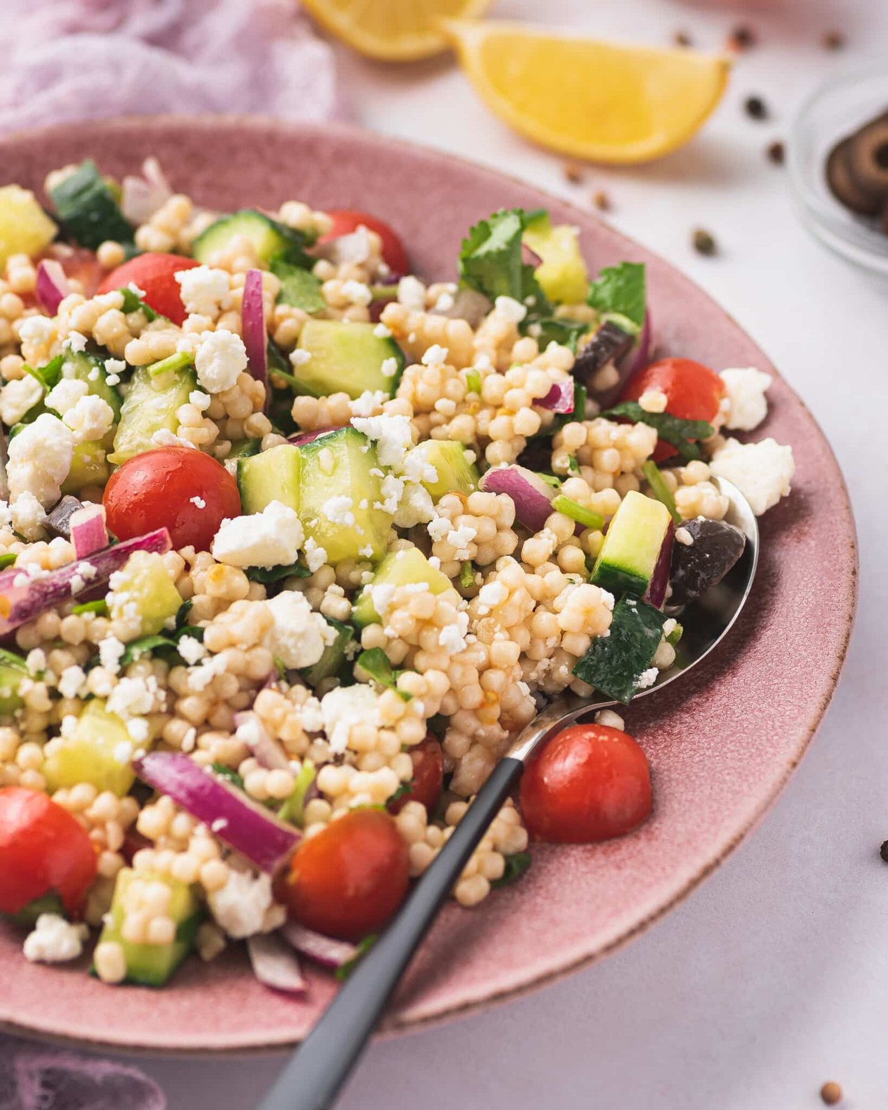 close up of mediterranean couscous salad
