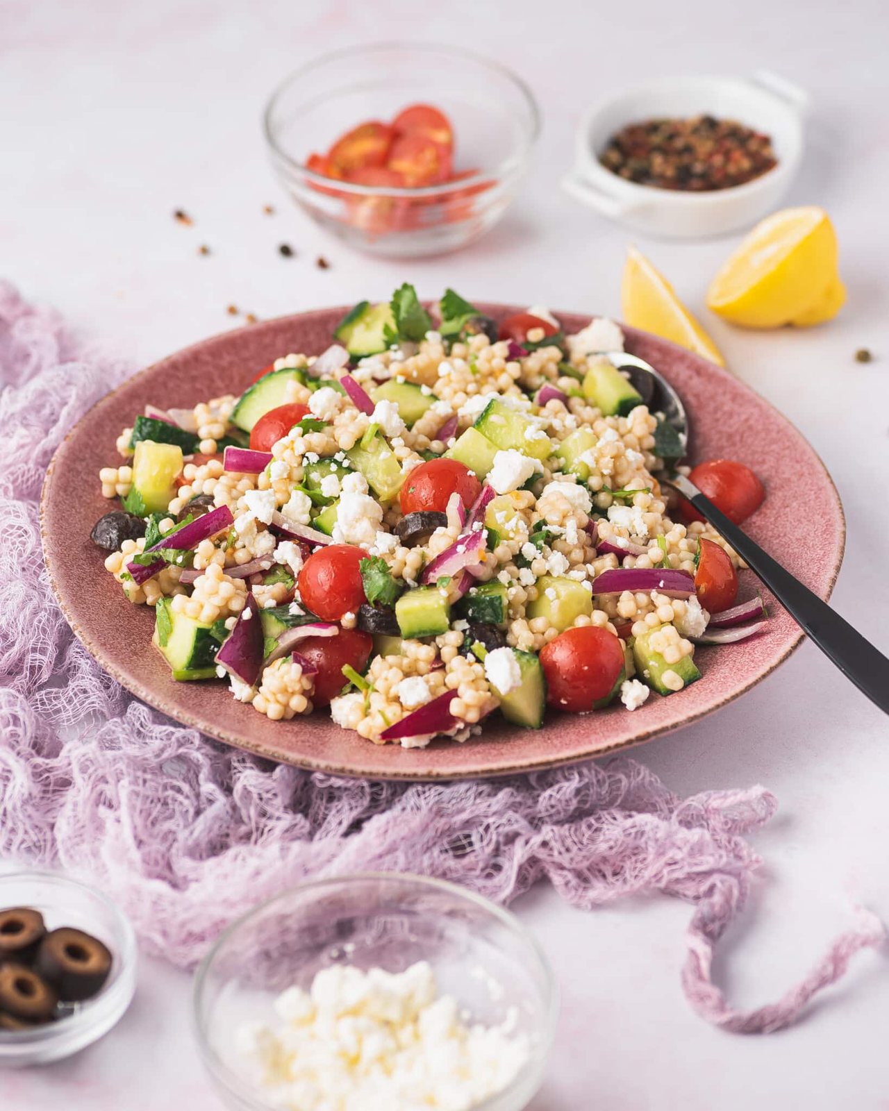 served pearl couscous salad with vegetables on a plate