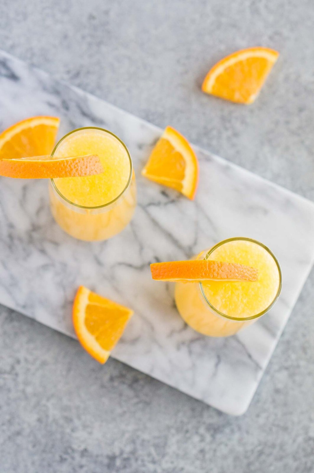 mimosa in glasses garnished with orange slices