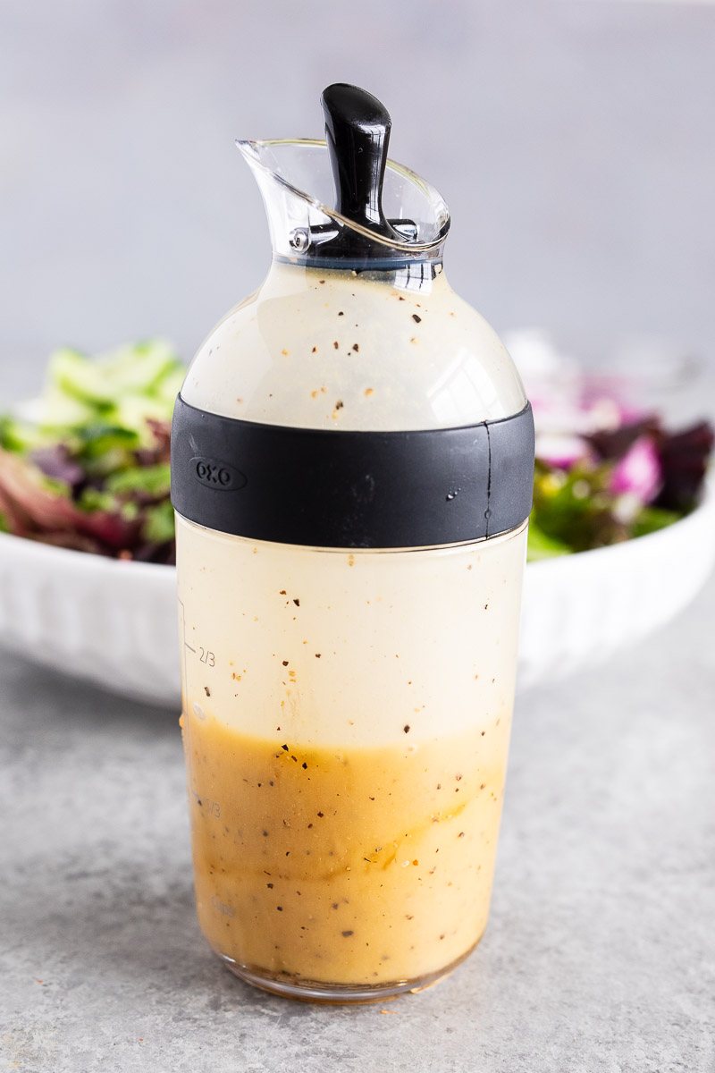 honey dijon dressing in a dressing shaker bottle