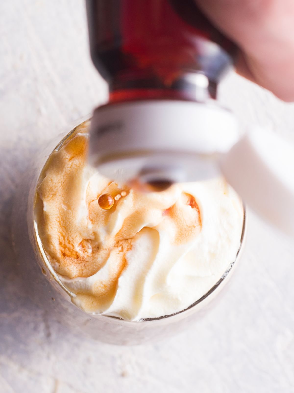 adding whipped cream and chocolate to mocha