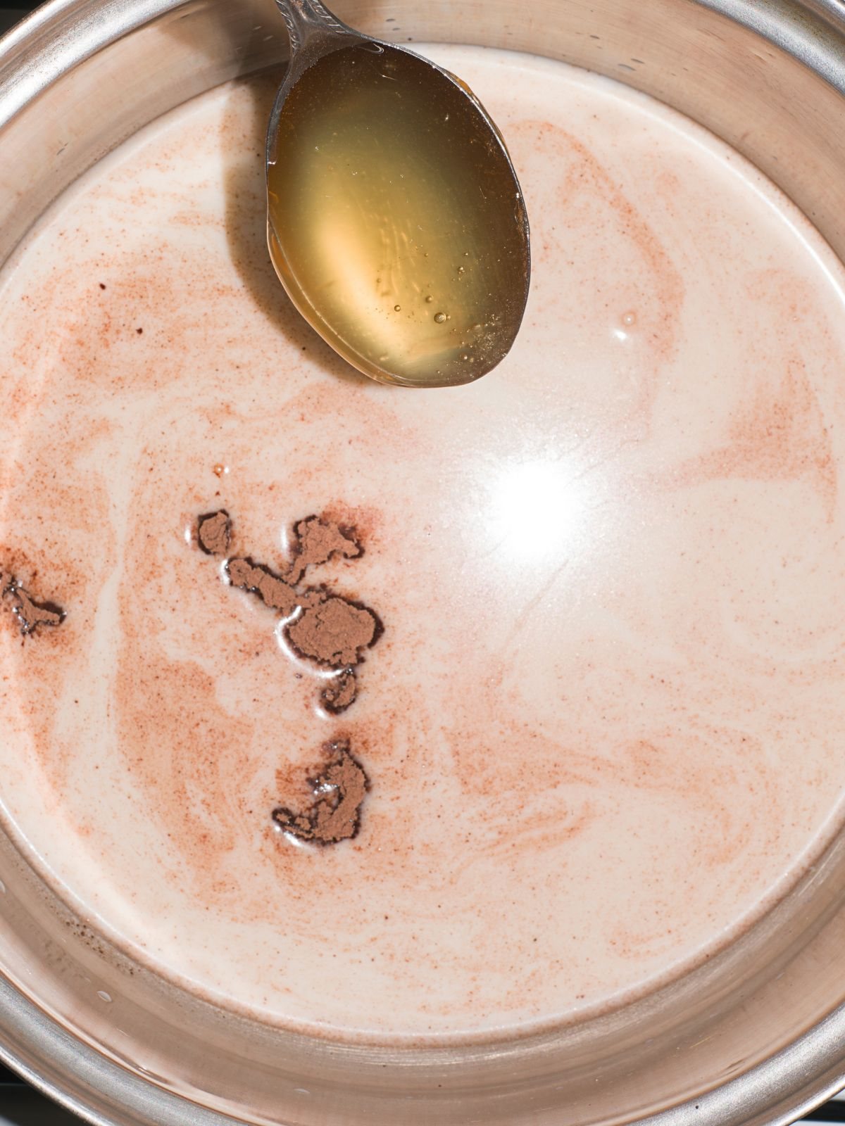 heating up milk, cocoa powder and honey
