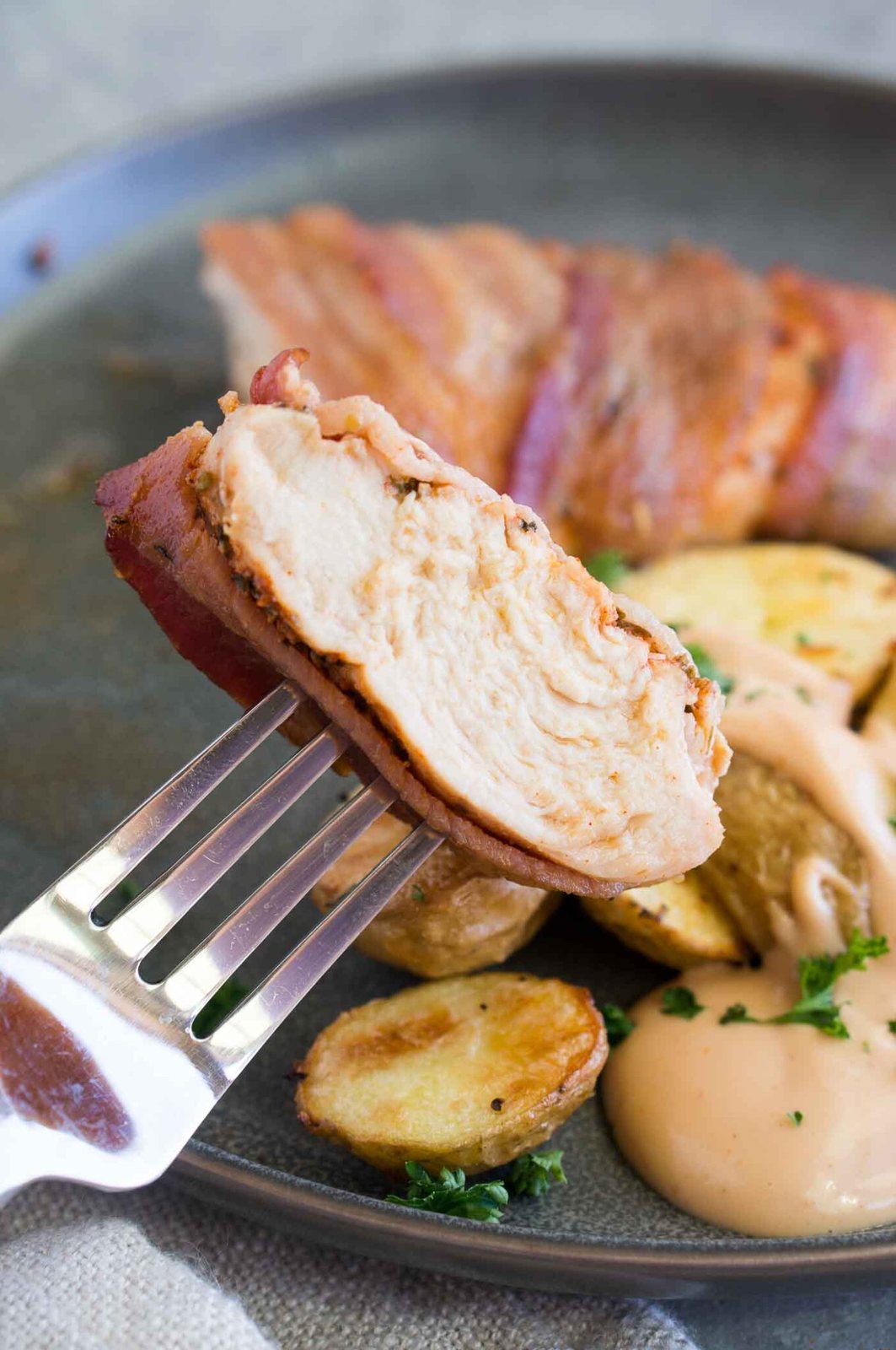 a bite of bacon wrapped chicken