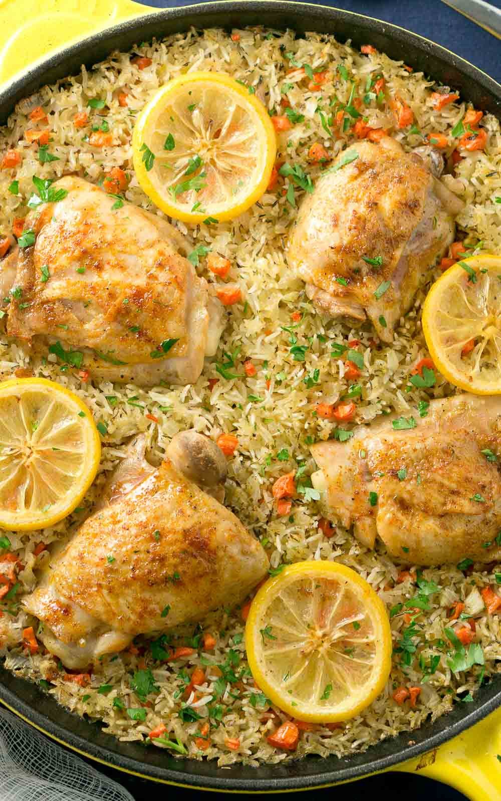 One Skillet Mediterranean Chicken and Rice is an easy and delicious meal the whole family will love. Garlic-seasoned chicken thighs on a bed of rice mixed with colorful veggies.