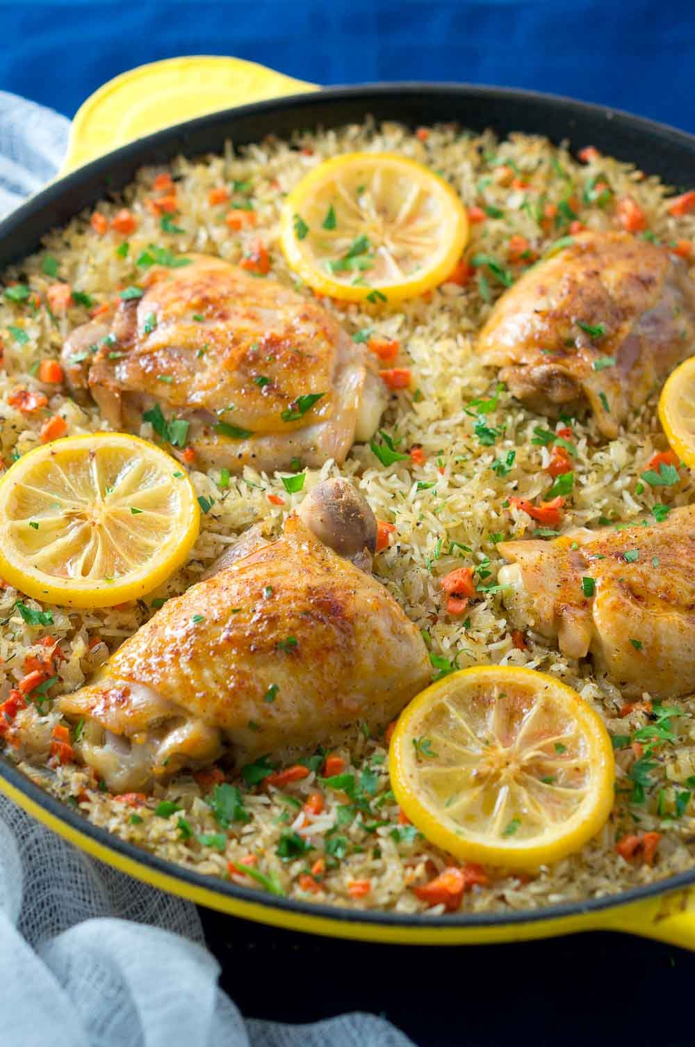 One Skillet Mediterranean Chicken and Rice is an easy and delicious meal the whole family will love. Garlic-seasoned chicken thighs on a bed of rice mixed with colorful veggies.