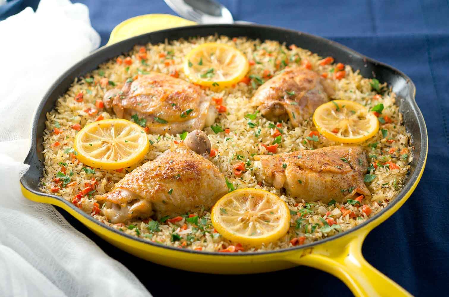 One Skillet Mediterranean Chicken and Rice is an easy and delicious meal the whole family will love. Garlic-seasoned chicken thighs on a bed of rice mixed with colorful veggies.