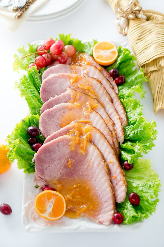 Orange Dijon Glazed Ham - Succulent spiral ham is brushed with a sweet and tangy orange dijon glaze, then roasted until perfection, creating a delicious caramelized outer layer.