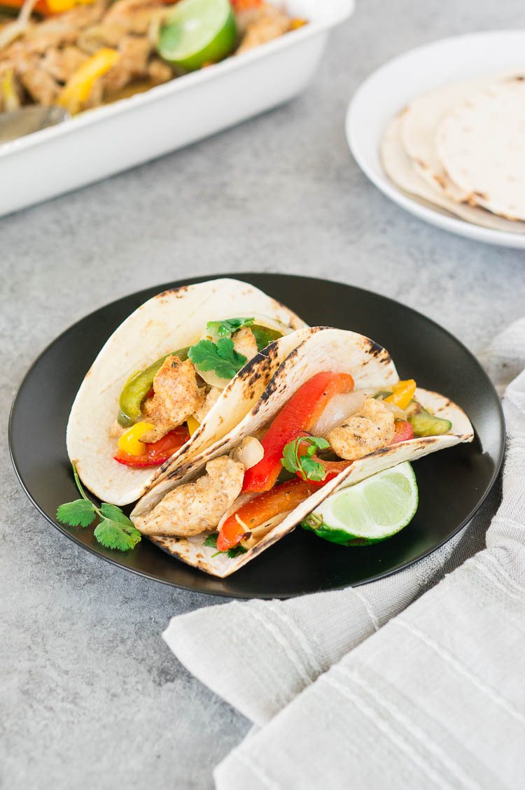 chicken fajitas on a tortilla with lime