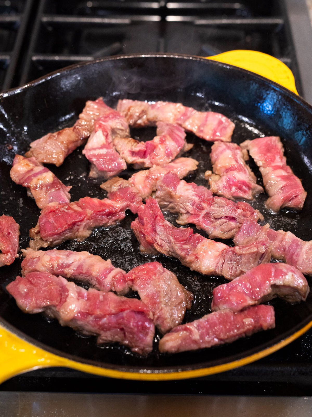 cooking flank steak in a skillet