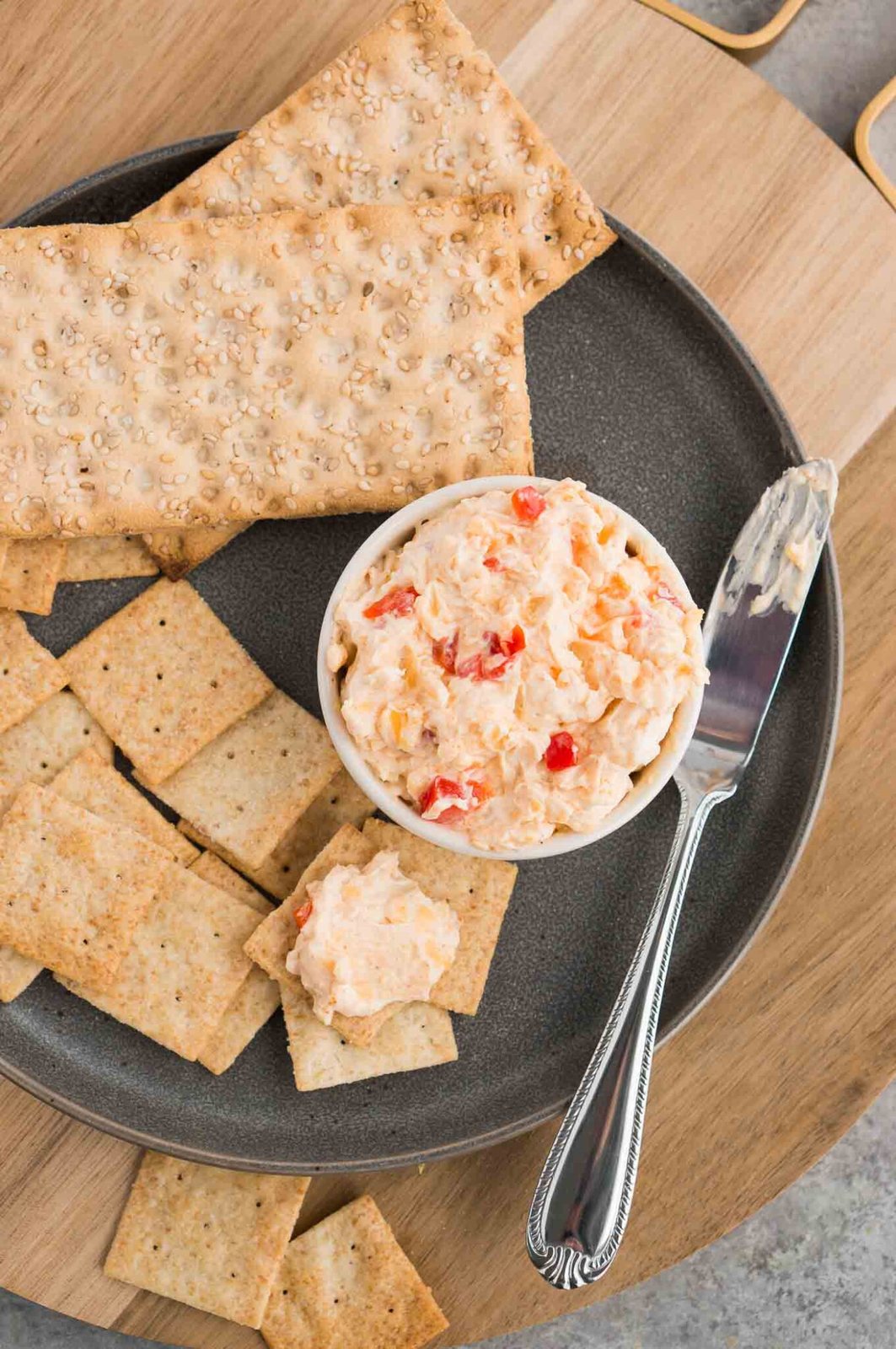 image from top of pimento spread in a bowl and crackers on a plate